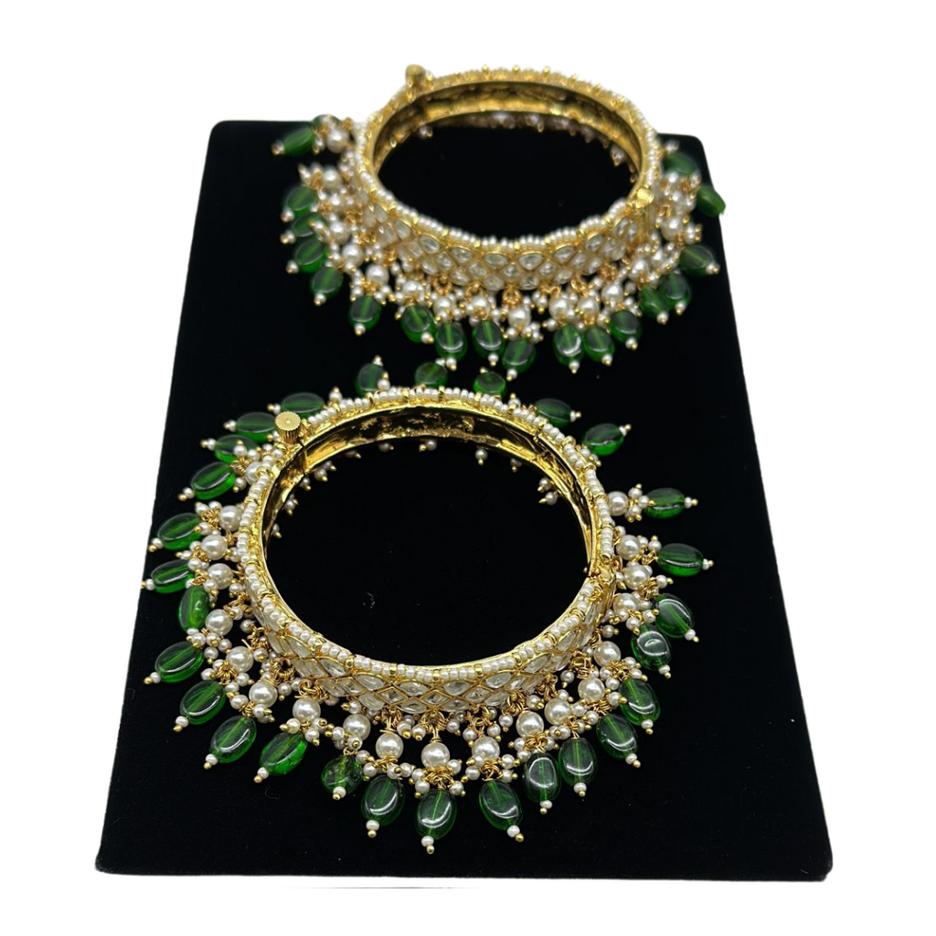 Pair of kundan bangles with lock and pearls and emeralds hanging