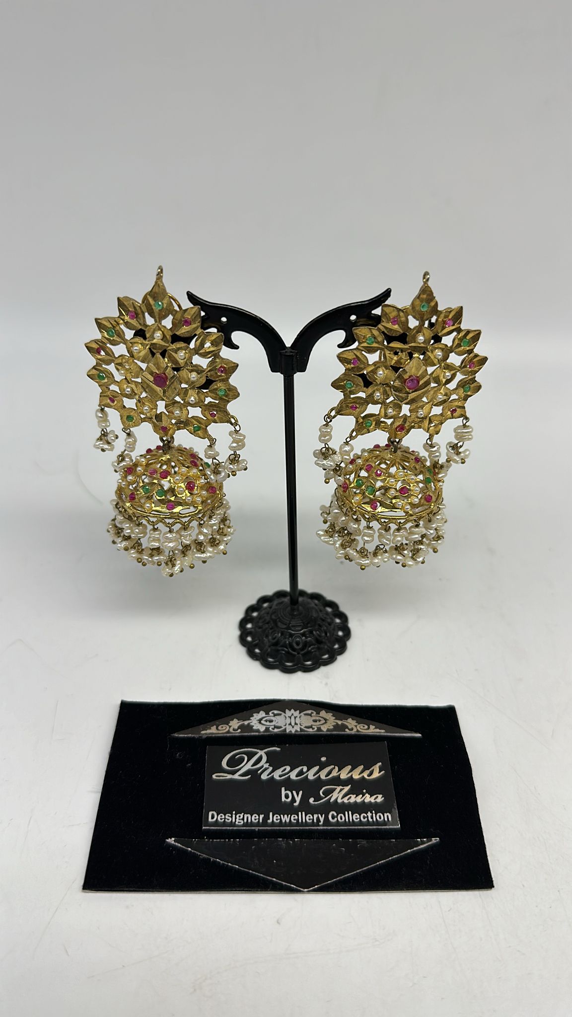 Classic traditional gold inspired handmade jhumke with ruby's and emeralds stones and real pearls finish