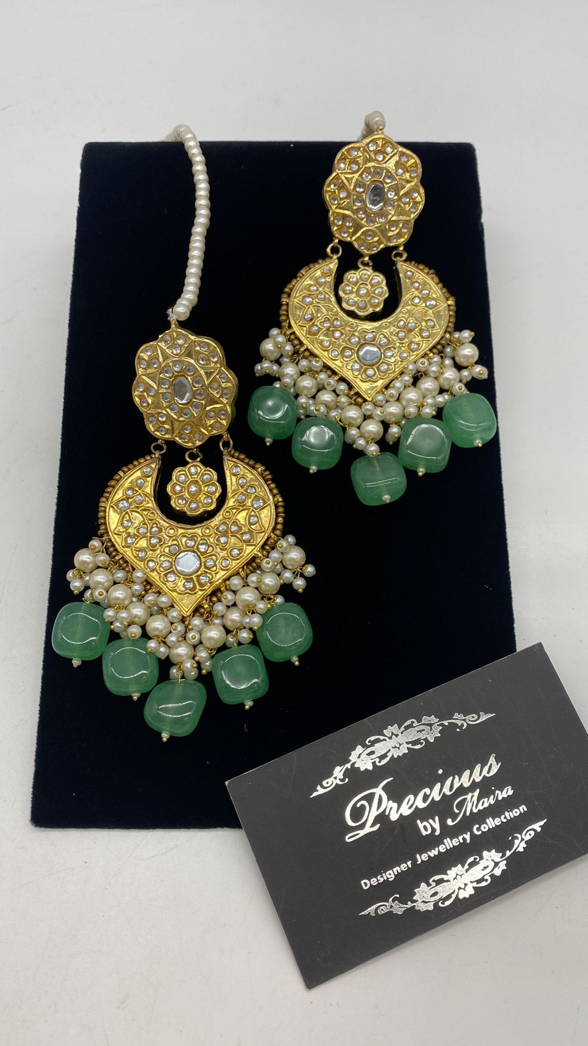 Chand Bali style kundan earrings with chunks of pearl hanging and semi precious emerald droplets